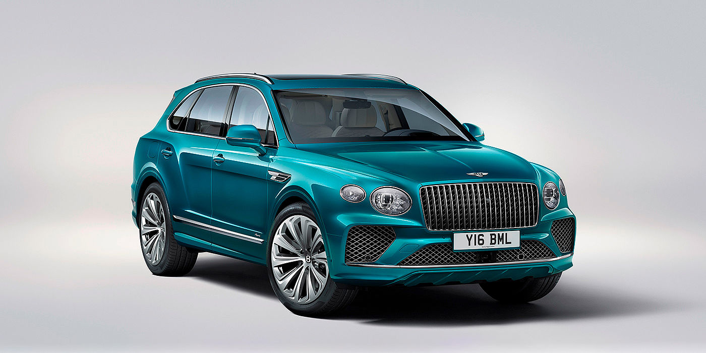 Bentley Katowice Bentley Bentayga Azure front three-quarter view, featuring a fluted chrome grille with a matrix lower grille and chrome accents in Topaz blue paint.