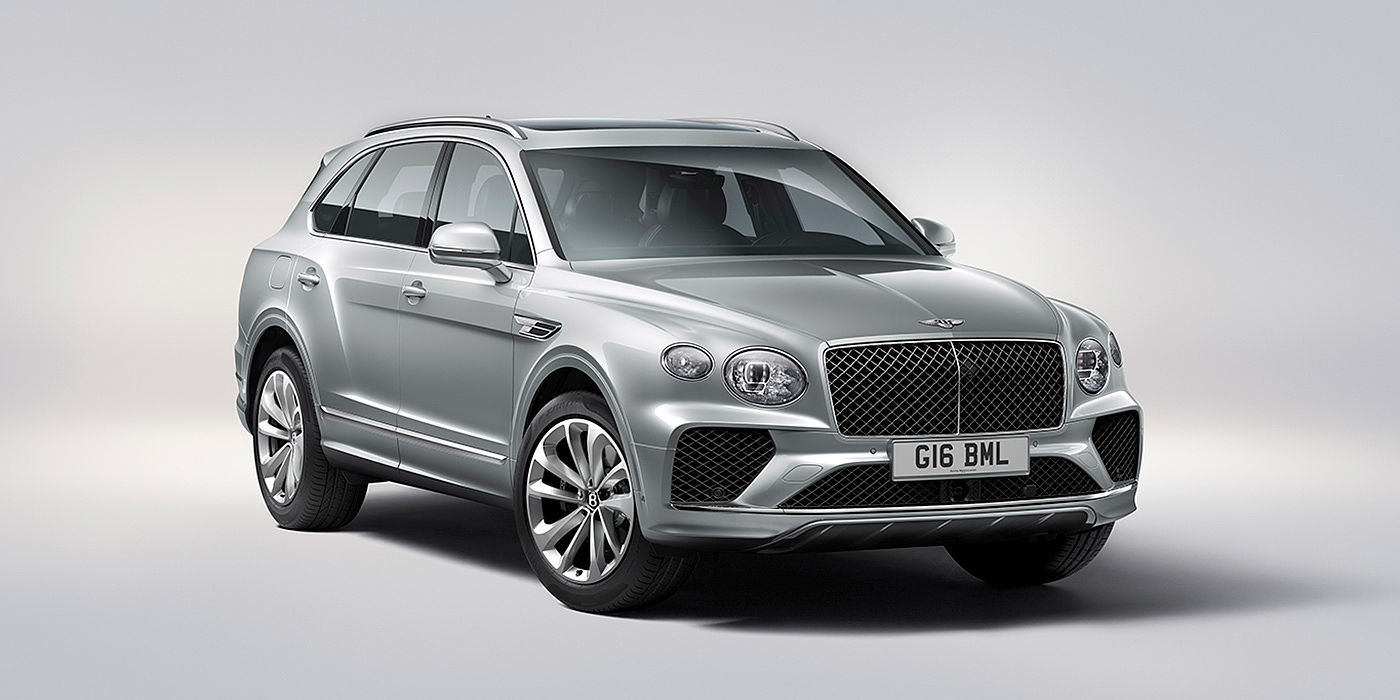 Bentley Katowice Bentley Bentayga in Moonbeam paint, front three-quarter view, featuring a matrix grille and elliptical LED headlights.
