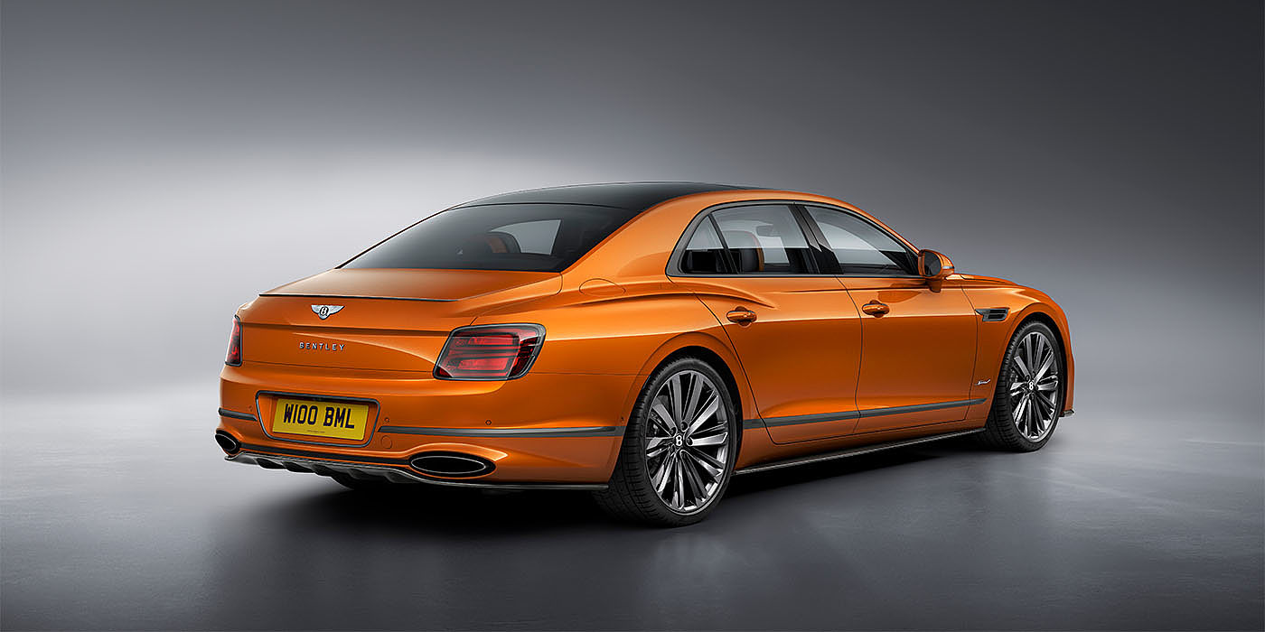 Bentley Katowice Bentley Flying Spur Speed in Orange Flame colour rear view, featuring Bentley insignia and enhanced exhaust muffler.