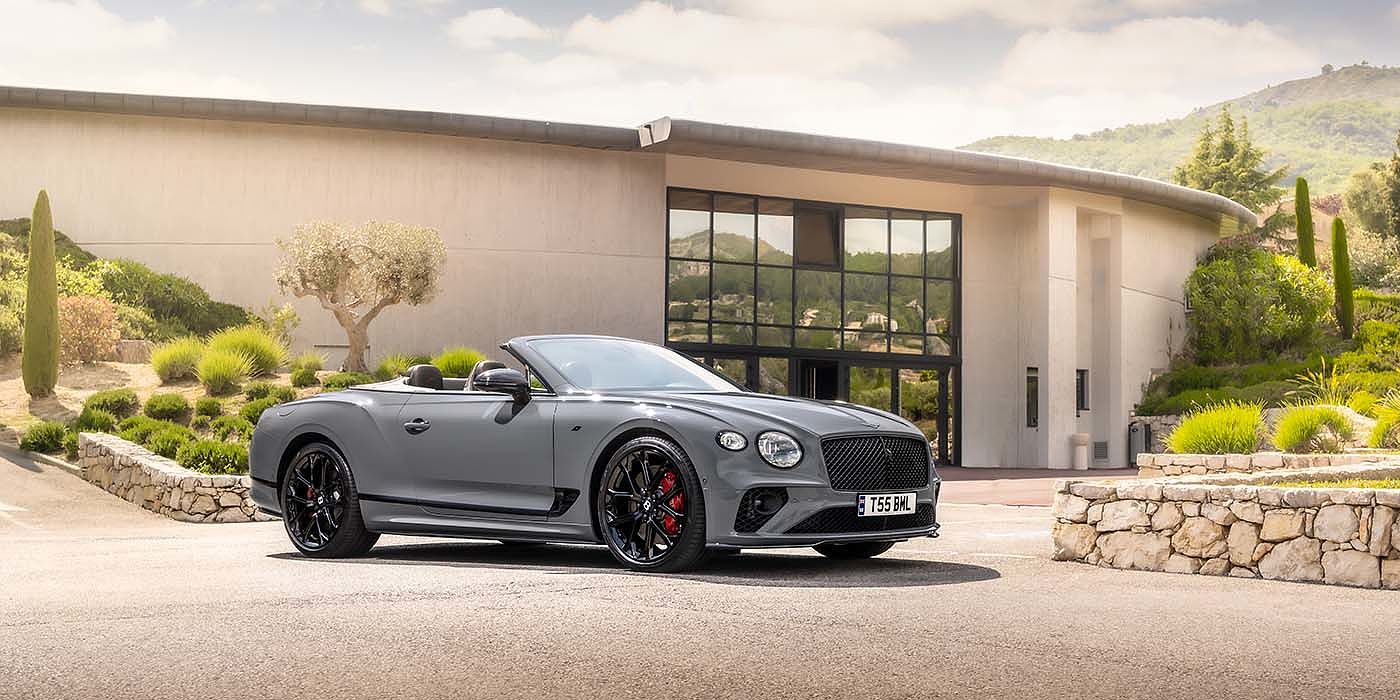 Bentley Katowice Bentley Continental GTC S convertible in Cambrian Grey paint front 34 static near house