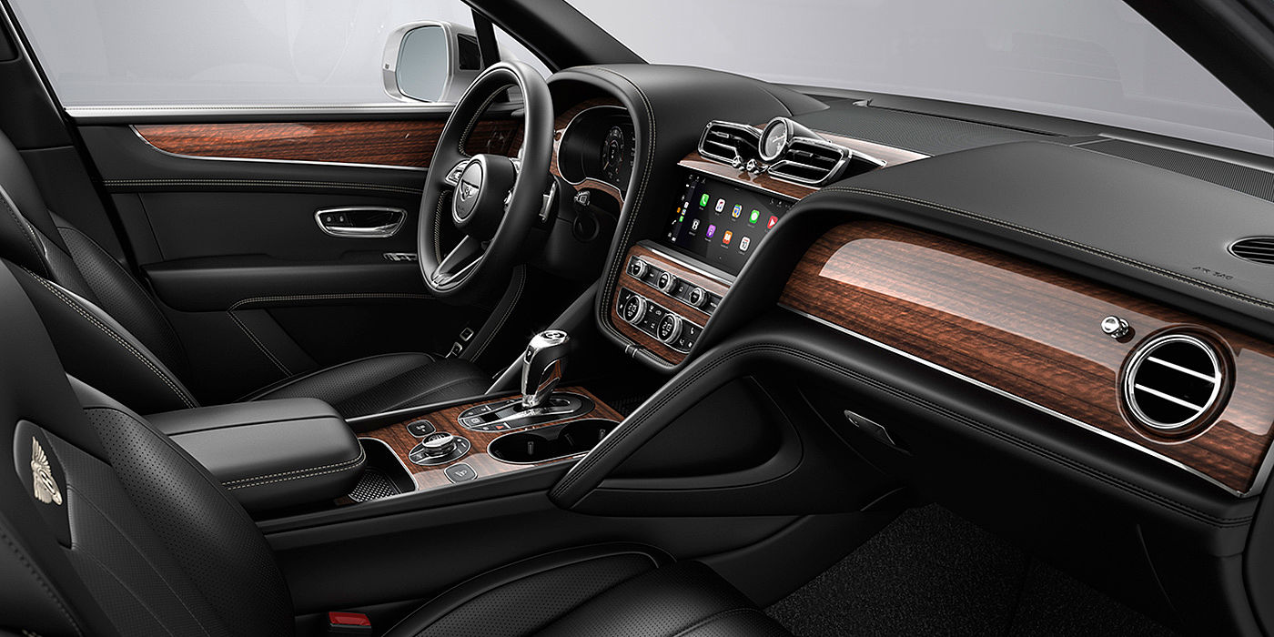 Bentley Katowice Bentley Bentayga interior with a Crown Cut Walnut veneer, view from the passenger seat over looking the driver's seat.