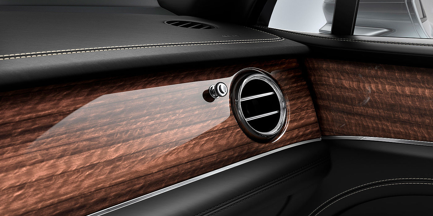 Bentley Katowice Bentley Bentayga front interior Crown Cut Walnut veneer and chrome air vent.