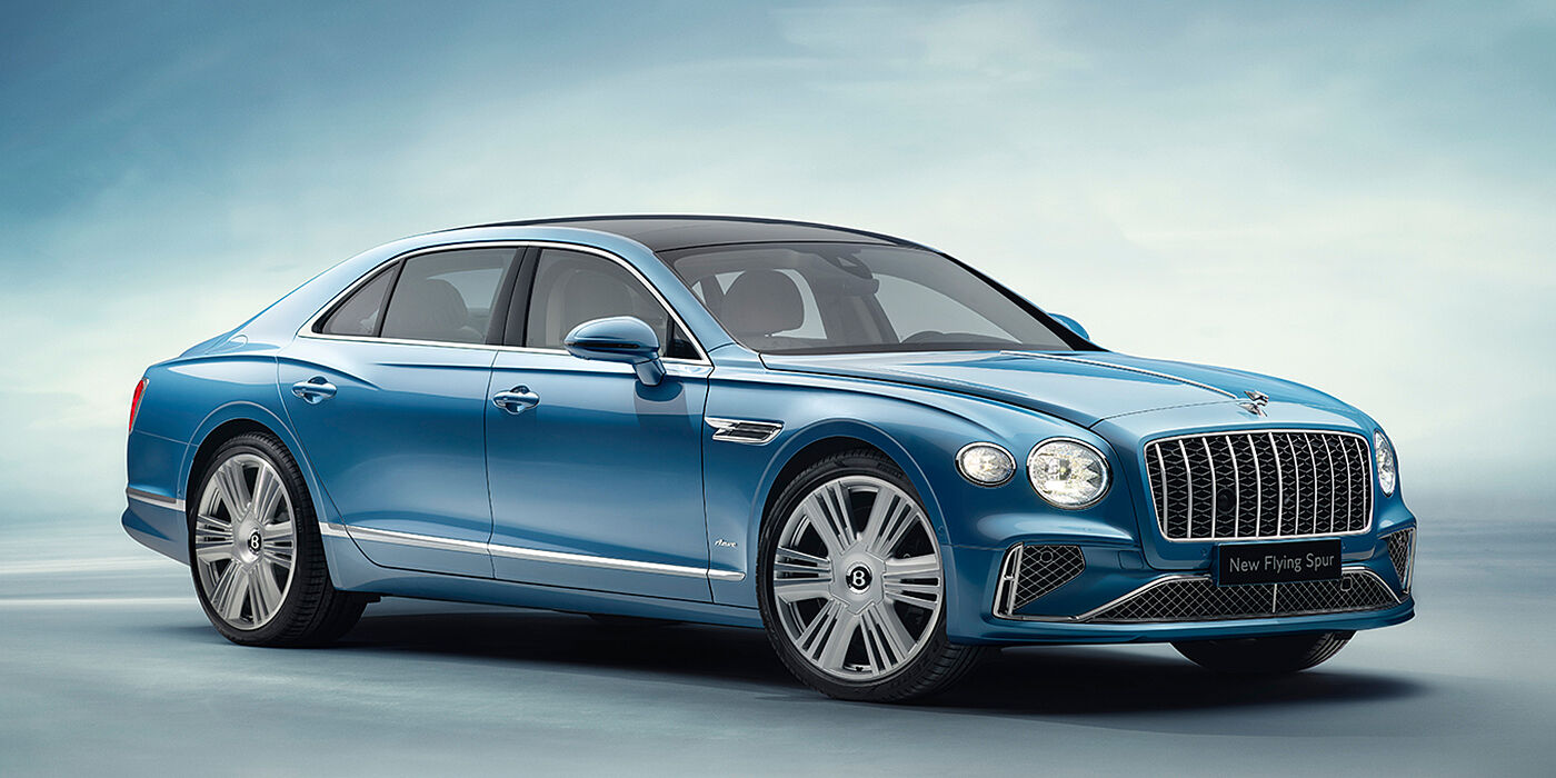 Bentley Katowice New Bentley Flying Spur Azure sedan front view in Light windsor blue by Mulliner paint with 22 inch Azure wheels and chrome exterior details