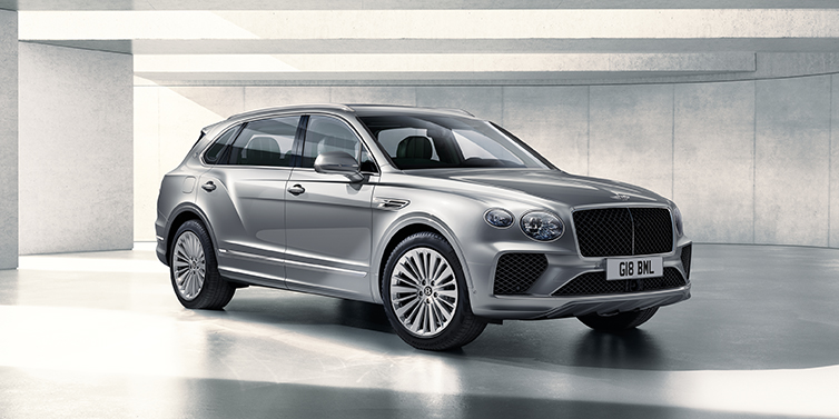 Bentley Katowice Bentley Bentayga Extended Wheelbase SUV front three quarter in Moonbeam paint with a grey background