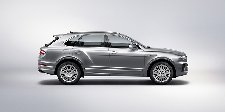 Bentley Katowice Bentley Bentayga SUV side profile in Moonbeam silver paint against white background featuring 21 inch 5 spoke wheels